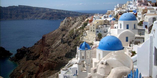 This Sept. 21, 2009 photo shows a view of Oia village on the island of Santorini, Greece. The Greek island of Santorini offers seaside tavernas, cliffside paths, black volcanic rocks and of course, sunshine and the Aegean. (AP Photo/Michael Virtanen)