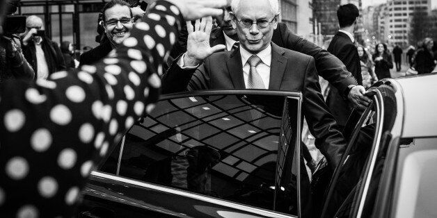 Outgoing European Council President Herman Van Rompuy, says goodbye to his coworkers for the last time while stepping into a car in front of the Justus Lipsius building after walking over a red carpet at the handover ceremony for the European Council Presidency at the EU Council building in Brussels on Monday, Dec. 1, 2014. (Photo by Sander de Wilde/Corbis via Getty Images)