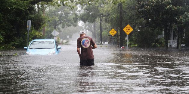 ST AUGUSTINE, FL - OCTOBER 07: Paul (last name not given) walks through a flooded street as Hurricane Matthew passes through the area on October 7, 2016 in St Augustine, Florida. Florida, Georgia, South Carolina and North Carolina all declared a state of emergency in anticipation of Hurricane Matthew. (Photo by Joe Raedle/Getty Images)