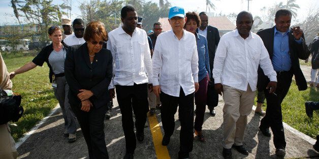 U.N. Secretary-General Ban Ki-moon, center, walks with U.N. Head of Mission for Haiti, Sandra Honore, left, and Haiti's Prime Minister Enex Jean-Charles, second from left, as he walks to a helicopter after visiting a school where people are sheltered after losing their homes to Hurricane Matthew in Les Cayes, Haiti, Saturday, Oct. 15, 2016. Ban Ki-moon arrived to see firsthand a sliver of the extensive destruction left by the storm as victims continued to express frustration at delays in aid more than a week-and-a-half since the Category 4 storm hit. (AP Photo/Rebecca Blackwell)