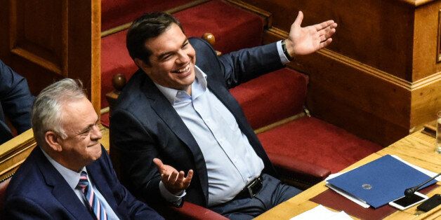 Prime Minister Alexis Tsipras smiles in the Hellenic Parliament during parliamentary dispute at level of Party leaders on the topic of corruption in Athens on October 10, 2016. (Photo by Wassilios Aswestopoulos/NurPhoto via Getty Images)