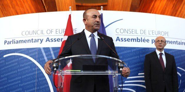 STRASBOURG, FRANCE - OCTOBER 12: Turkish Foreign Minister Mevlut Cavusoglu (C) delivers a speech with Secretary General of the Council of Europe, Thorbjorn Jagland (not seen) and Parliamentary Assembly of Council of Europe (PACE) President Pedro Agramunt (not seen) prior to the opening ceremony of the Anadolu Agency's July 15th photography exhibition in Strasbourg, France on October 12, 2016. (Photo by Turkish Foreign Ministry / Ahmet Gumus/Anadolu Agency/Getty Images)