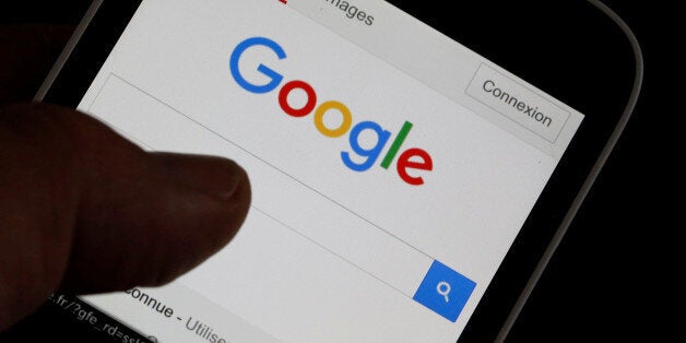 A man holds his smartphone which displays the Google home page, in this picture illustration taken in Bordeaux, Southwestern France, August 22, 2016. REUTERS/Regis Duvignau