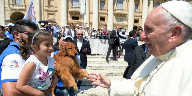 Pope Francis greets members of a marine search and rescue dogs school at the end of his weekly general audience in St. Peter's Square at the Vatican, Wednesday, June 8, 2016. (L'Osservatore Romano Pool Photo Via AP)