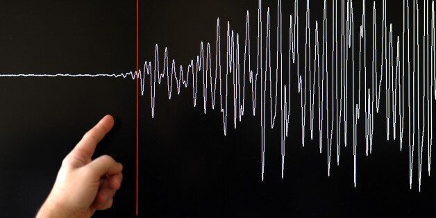 A technician of the French National Seism Survey Institute (RENASS) presents a graph on March 11, 2011 in Strasbourg, Eastern France, registered today during a major earthquake in Japan. A 8.9 magnitude quake hit northeast Japan today, causing many injuries, deaths, fires and a tsunami along parts of the country's coastline. AFP PHOTO / FREDERICK FLORIN (Photo credit should read FREDERICK FLORIN/AFP/Getty Images)