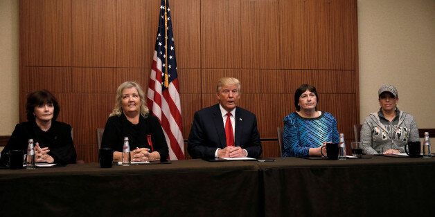 Republican presidential nominee Donald Trump sits with (from R-L) Paula Jones, Kathy Shelton, Juanita Broaddrick, Kathleen Willey in a hotel conference room in St. Louis, Missouri, U.S., shortly before the second presidential debate at Washington University in St. Louis, October 9, 2016. REUTERS/Mike Segar TPX IMAGES OF THE DAY