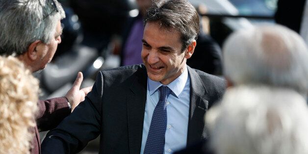 Newly elected leader of Greece's conservative New Democracy party Kyriakos Mitsotakis (C) is greeted by supporters as he arrives at the party's headquarters, a day after winning the party elections, in Athens, Greece January 11, 2016. REUTERS/Alkis Konstantinidis TPX IMAGES OF THE DAY TPX IMAGES OF THE DAY