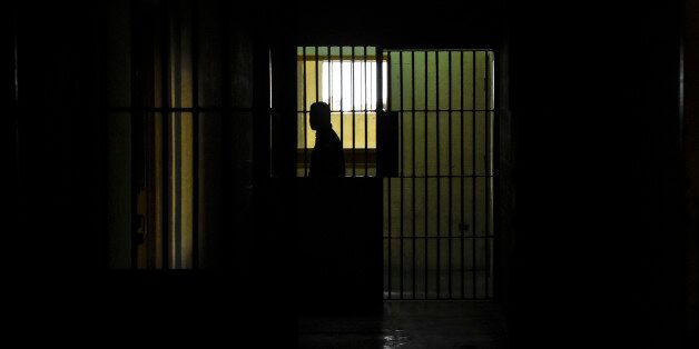 An inmate is seen in a sector of the El Rodeo prison where a new penitentiary system is being implemented and prisoners with good conduct receive military training, in Guatire, 20km from Caracas, on July 1, 2016. / AFP / JUAN BARRETO (Photo credit should read JUAN BARRETO/AFP/Getty Images)