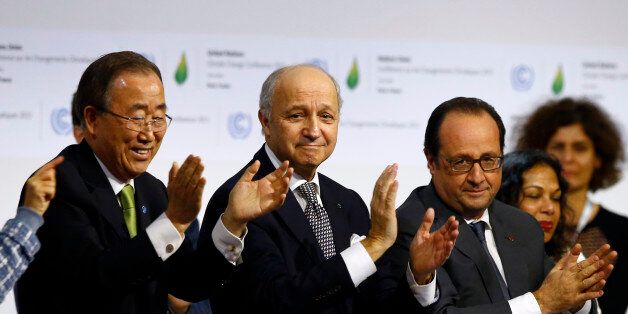 French President Francois Hollande, right, French Foreign Minister and president of the COP21 Laurent Fabius, center, and United Nations Secretary General Ban ki-Moon applaud after the final conference at the COP21, the United Nations conference on climate change, in Le Bourget, north of Paris, Saturday, Dec.12, 2015. Governments have adopted a global agreement that for the first time asks all countries to reduce or rein in their greenhouse gas emissions. (AP Photo/Francois Mori)