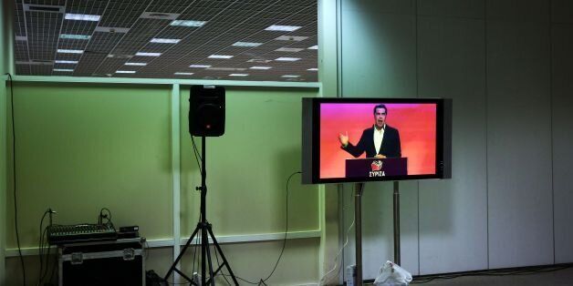 Greek Prime Minister Alexis Tsipras is seen on a TV screen as he delivers a speech during Syriza party's congress in Athens, on October 13, 2016. / AFP / Angelos TZORTZINIS (Photo credit should read ANGELOS TZORTZINIS/AFP/Getty Images)