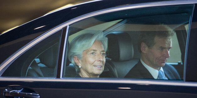 Christine Lagarde, managing director of the International Monetary Fund (IMF), left, and Poul Thomsen, European department director of the International Monetary Fund (IMF), sit in an automobile as they depart emergency talks in Brussels, Belgium, on Thursday, June 25, 2015. Greece and its creditors are holding marathon emergency talks, struggling to break a five-month impasse that has brought the country to the cusp of default as the end of its bailout program next Tuesday lurches ever closer. Photographer: Jasper Juinen/Bloomberg via Getty Images