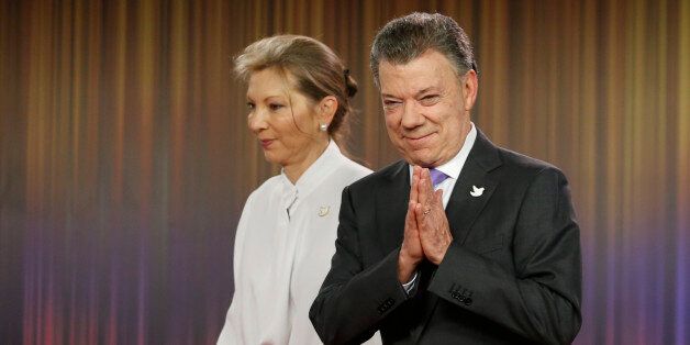 Colombia's President Juan Manuel Santos, right, arrives with his wife Maria Clemencia Rodirguez for a press conference at the presidential palace in Bogota, Colombia, Friday, Oct. 7, 2016. Colombian President Juan Manuel Santos won the Nobel Peace Prize Friday, just days after voters narrowly rejected a peace deal he signed with rebels of the Revolutionary Armed Forces of Colombia, FARC. (AP Photo/Fernando Vergara)