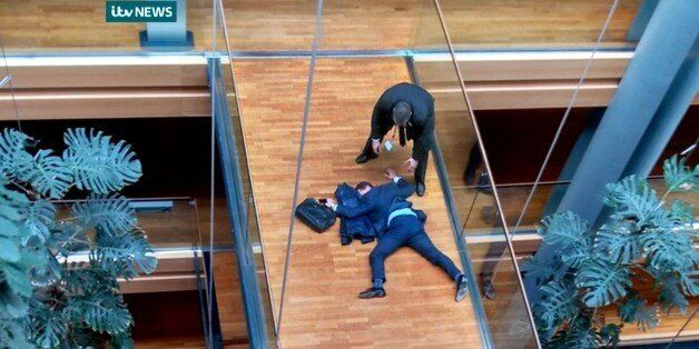 British UK Independence Party Member of the European Parliament Steven Woolfe lies on the ground after losing consciousness in the European Parliament building in Strasbourg France Thursday Oct. 6, 2015. Britain's fractious, right-wing U.K. Independence Party erupted into violence Thursday that left Steven Woolfe hospitalized with a head injury after an