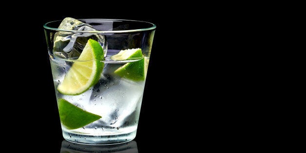 Vodka lime with ice in rocks glass on black background including clipping path