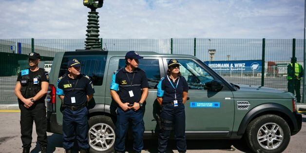 Romanian Border police officers look on during an inauguration ceremony of the new European Border and Coast Guard task force at the Kapitan Andreevo checkpoint, at the Bulgaria-Turkey border, on October 6, 2016. European Union officials inaugurated the new task force at the Kapitan Andreevo checkpoint on the Bulgarian-Turkish border, the main land frontier for migrants seeking to enter the bloc and avoid the dangerous Mediterranean sea crossing. The European Border and Coast Guard Agency (EBCG) will have at the ready some 1,500 officers from 19 member states who can be swiftly mobilised in case of an emergency, like a sudden surge of migrants. / AFP / DIMITAR DILKOFF (Photo credit should read DIMITAR DILKOFF/AFP/Getty Images)