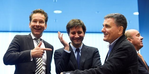 Dutch Finance Minister and president of Eurogroup Jeroen Dijsselbloem (L) talks with Greek Finance Minister Euclid Tsakalotos (R) next to a Greek advisor during an Eurogroup meeting in Luxembourg on October 10, 2016.Greece has delivered the reforms necessary to unlock 2.8 billion euros in rescue loans from its massive third bailout, the European Commission's top economics affairs official said on October 10, 2016. / AFP / JOHN THYS (Photo credit should read JOHN THYS/AFP/Getty Images)