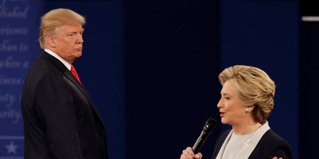 Republican presidential nominee Donald Trump listens to Democratic presidential nominee Hillary Clinton during the second presidential debate at Washington University in St. Louis, Sunday, Oct. 9, 2016. (AP Photo/Patrick Semansky)