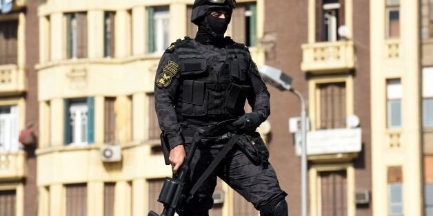 An Egyptian riot policeman stands guard on top of a vehicle protesters during a demonstration against a controversial deal to hand two islands in the Red Sea to Saudi Arabia on April 15, 2016 outside the Journalists' Syndicate in central Cairo. Outside the Journalists' Syndicate in central Cairo, about 200 protesters chanted 'down with military rule', the signature slogan of the 2011 Arab Spring uprisings. The deal to hand over two islands in the Straits of Tiran, signed during a visit by Saudi Arabia's King Salman to Cairo last week, has provoked a storm of criticism against Egyptian President Abdel Fattah al-Sisi. / AFP / MOHAMED EL-SHAHED (Photo credit should read MOHAMED EL-SHAHED/AFP/Getty Images)