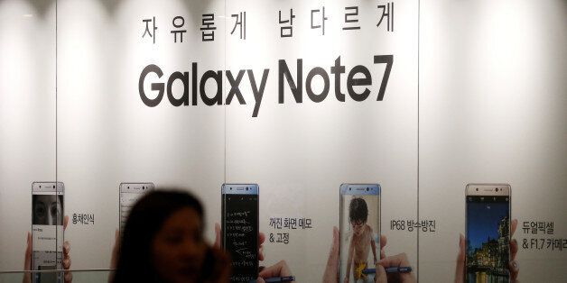 A woman talking on her mobile phone walks past an advertisement promoting Samsung Electronics' Galaxy Note 7 at company's headquarters in Seoul, South Korea, October 11, 2016. REUTERS/Kim Hong-Ji