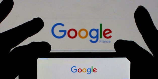A woman holds her smart phone which displays the Google home page, in this picture illustration taken February 24, 2016. A U.S. Jury handed Google a major victory May 26, 2016 in a long-running copyright battle with Oracle Corp over Android software to run most of the world's smartphones. REUTERS/Eric Gaillard/Illustration/Files