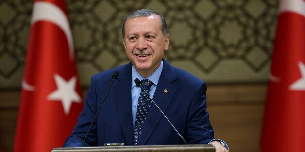 Turkey's President Recep Tayyip Erdogan addresses a group of local administrators in Ankara, Turkey, Thursday, Sept. 29, 2016. Erdogan hinted on Thursday that the three-month state of emergency declared following the failed July 15 coup could be extended to over a year. Erdogan dismissed criticism over plans for Turkey to prolong the state of emergency, saying no one should determine a