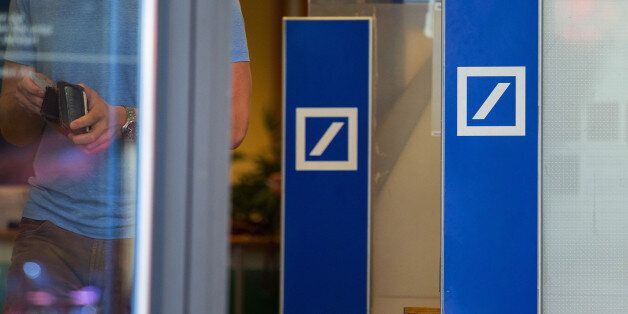 The logo for Deutsche Bank AG sit on door handles at a bank branch in Berlin, Germany, on Tuesday, Sept. 27, 2016. Deutsche Bank AG rose in Frankfurt trading after the German lender agreed to sell its U.K. insurance business for 935 million euros ($1.2 billion) and Chief Executive Officer John Cryan ruled out a capital increase. Photographer: Krisztian Bocsi/Bloomberg via Getty Images