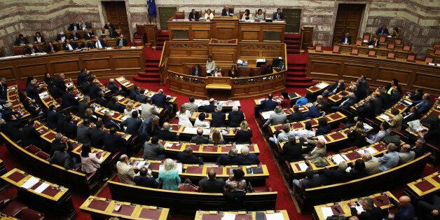 Greek lawmakers attent a Parliament meeting to vote on a proposal to move control of public utilities to a new asset fund created by international bailout creditors, in Athens, Tuesday, Sept. 27, 2016. (AP Photo/Petros Giannakouris)