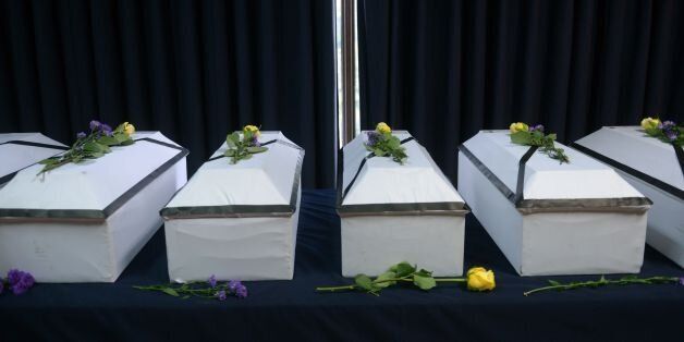 Coffins with the remains of 11 victims of the 1981 El Mozote massacre are lined up to be handed over to their relatives at the Supreme Court of Justice in San Salvador, on May 20, 2016.Salvador's Supreme Court of Justice handed the exhumed remains of 11 victims of the El Mozote massacre to their families following mitochondrial DNA tests. In December 1981, members of the US-trained Salvadorean elite Atlacatl battalion killed more than a thousand peasants during counter-insurgency operations in El Mozote and neighbouring sectors, in an episode known as the El Mozote Slaughter. / AFP / Marvin RECINOS (Photo credit should read MARVIN RECINOS/AFP/Getty Images)