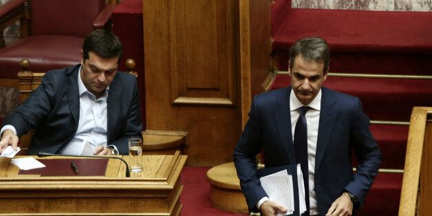 Greek PM Alexis Tsipras (L) and Kyriakos Mitsotakis, New Democracy and main opposition leader, during a debate on education in the Greek Parliament, in Athens on September 28 (Photo by Panayiotis Tzamaros/NurPhoto via Getty Images)