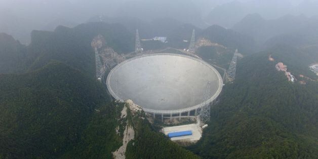 The Five-hundred-metre Aperture Spherical Radio Telescope (FAST) is seen on its first day of operation in Pingtang, in southwestern China's Guizhou province on September 25, 2016.The world's largest radio telescope began operating in southwestern China on September 25, a project which Beijing says will help humanity search for alien life. / AFP / STR / China OUT (Photo credit should read STR/AFP/Getty Images)