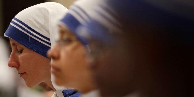 Nuns of Mother Teresa's Missionaries of Charity, pray during a vigil of prayer in preparation for the canonization of Mother Theresa in the St. John in Lateran Basilica in Rome, Friday, Sept. 2, 2016. (AP Photo/Gregorio Borgia)