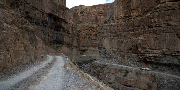 In this Aug. 15, 2016, photo, a car drives along a mountain road that leads to Spiti Valley, a remote...