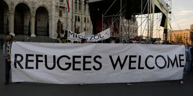 HUNGARIAN PARLIAMENT BUILDING, BUDAPEST, CENTRAL HUNGARY, HUNGARY - 2016/09/30: Activists hold a Refugees Welcome banner. A few thousand activists rallied outside the Hungarian Parliament, calling people to boycott the upcoming Hungarian migrant quota referendum. The rally was organised by the Hungarian Helsinki Committee. (Photo by Michael Debets/Pacific Press/LightRocket via Getty Images)