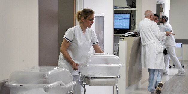 A nurse arranges newborn's cots at a maternity hospital in Athens on April 12, 2013. Sunk in recession for the past six years and struggling to steer its economy through painful austerity cuts, Greece now faces a fertility crisis as well. 'Benefits have been cut, the cost of living has risen, wages are down and there is great uncertainty' says Leonidas Papadopoulos, managing director of a hospital and a veteran obstetrician .AFP PHOTO/ LOUISA GOULIAMAKI (Photo credit should read LOUISA GOULIAMAKI/AFP/Getty Images)