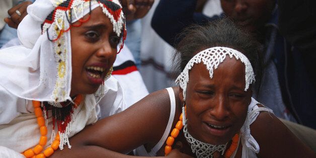 Women react at a protest during Irreecha, the thanksgiving festival of the Oromo people, in Bishoftu town, Oromia region, Ethiopia, October 2, 2016. REUTERS/Tiksa Negeri