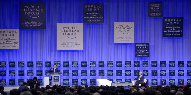 China's Premier Li Keqiang (L) gives a speech as Founder and executive chairman of the WEF Klaus Schwab (R) listens during the summer World Economic Forum in Tianjin, China, June 27, 2016. REUTERS/Wang Zhao/Pool