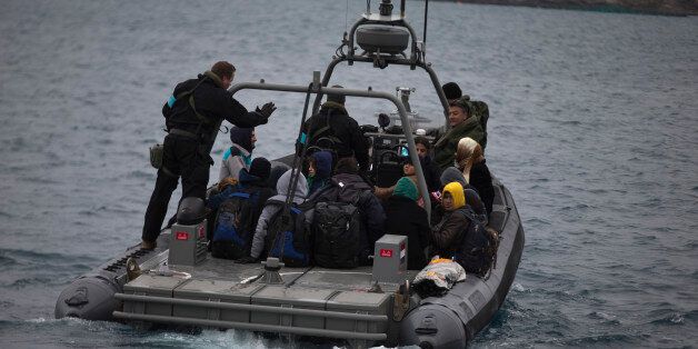 In this photo taken on Wednesday, Jan. 20, 2016, a Frontex speedboat with a Dutch crew transfers about 25 refugees and migrants from the deserted Greek island of Pasas to the nearby island of Oinousses, near Chios island. Chios, second in the number of arrivals after Lesbos, has three coast guard vessels as well as Frontex reinforcements. Hour after hour, by night and by day, Greek coast guard patrol and lifeboats, reinforced by vessels from the European Unionâs border agency Frontex, ply the waters of the eastern Aegean Sea along the frontier with Turkey, on the lookout for people being smuggled onto the shores of Greek islands - the frontline of Europeâs massive refugee crisis. (AP Photo/Petros Giannakouris)
