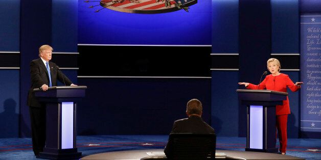 Democratic presidential nominee Hillary Clinton answers a question as Republican presidential nominee Donald Trump listens during the presidential debate at Hofstra University in Hempstead, N.Y., Monday, Sept. 26, 2016. (AP Photo/David Goldman)