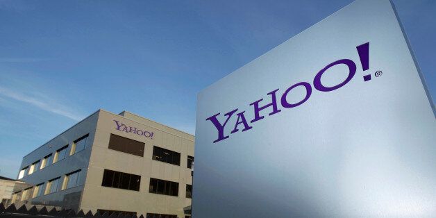 A Yahoo logo is pictured in front of a building in Rolle, 30 km (19 miles) east of Geneva, December 12, 2012. REUTERS/Denis Balibouse/File photo