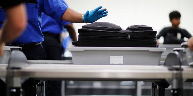 A bag to be screened waits to move along an automated conveyer belt as new bins are automatically recirculated underneath for passengers entering a newly designed screening lane unveiled at Hartsfield-Jackson Atlanta International Airport Wednesday, May 25, 2016, in Atlanta. The new screening lanes allow multiple passengers to load their belongings onto an automated conveyer belt at the same time. The lanes, the first of its kind in the nation, are aimed at speeding up the security process and are modeled on similar systems at London's Heathrow and Amsterdam's Schiphol airports. (AP Photo/David Goldman)