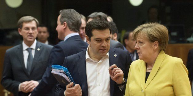 Greek Prime Minister Alexis Tsipras (L) talks with German Chancellor Angela Merkel (R) during the European Union summit at the EU Headquarters in Brussels on March 18, 2016. / AFP / JOHN THYS (Photo credit should read JOHN THYS/AFP/Getty Images)