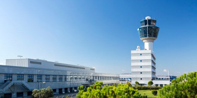 Modern air traffic control tower of the airport of Athens in Greece against clear and beautiful blue sky.