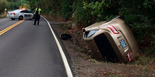 This photo provided by the Washington County Sheriff's office shows the accident scene where police say a woman freaked out by a falling spider, flipped her car in Portland, Ore., Wednesday, Sept. 21, 2016. The Washington County Sheriff's Office tweeted Wednesday that the spider dropped from the rearview mirror as the woman was driving on a rural road and that although the car was totaled in the rollover crash, the driver was not hurt. (Multnomah County Sheriff's Office via AP)