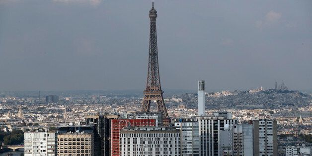 The Eiffel tower is pictured behind buildings in Paris, Wednesday, Sept. 21, 2016. The iron lattice tower is located on the Champ de Mars and designed in 1889 by Gustave Eiffel. (AP Photo/Christophe Ena)