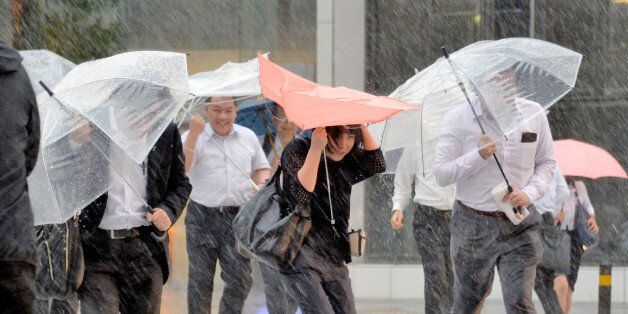 Pedestrians holding umbrellas struggle against strong wind and heavy rains caused by Typhoon Malakas in Nagoya, central Japan, in this photo taken by Kyodo September 20, 2016. Mandatory credit Kyodo/via REUTERS ATTENTION EDITORS - THIS IMAGE WAS PROVIDED BY A THIRD PARTY. EDITORIAL USE ONLY. MANDATORY CREDIT. JAPAN OUT. NO COMMERCIAL OR EDITORIAL SALES IN JAPAN. TPX IMAGES OF THE DAY