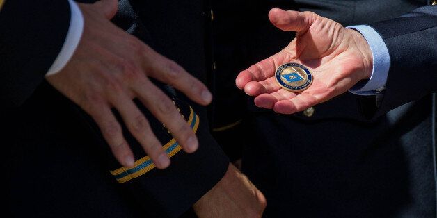 ARLINGTON, VA - OCTOBER 03: U.S. Defense Secretary Ash Carter hands out challenge coins during a ceremony honoring 2016 active duty military Olympians and Paralympians at The Pentagon on October 3, 2016 in Arlington, Virginia. The ceremony hosted 20 members of the U.S. military who competed in the 2016 games. (Photo by Zach Gibson/Getty Images)