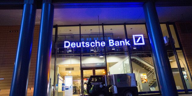 A road cleaning machine drives past the exterior of a Deutsche Bank AG bank branch in Berlin, Germany, on Wednesday, Sept. 28, 2016. Deutsche Bank AG rose in Frankfurt trading after the German lender agreed to sell its U.K. insurance business for 935 million euros ($1.2 billion) and Chief Executive Officer John Cryan ruled out a capital increase. Photographer: Krisztian Bocsi/Bloomberg via Getty Images