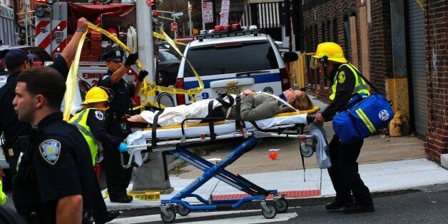 An injured woman is evacuated at New Jersey Transit's rail station in Hoboken, New Jersey September 29, 2016.A commuter train crashed into a station in New Jersey during the morning rush hour on Thursday, officials said, with dozens of people reportedly injured. 'Due to a NJ Transit train derailment at #Hoboken Station, NJ, all PATH train service in and out of Hoboken Station is suspended,' New York's official emergency information system tweeted. / AFP / KENA BETANCUR (Photo credit should read KENA BETANCUR/AFP/Getty Images)