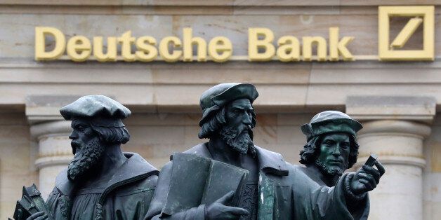 A statue is pictured next to the logo of Germany's Deutsche Bank in Frankfurt, Germany, September 30, 2016. REUTERS/Kai Pfaffenbach