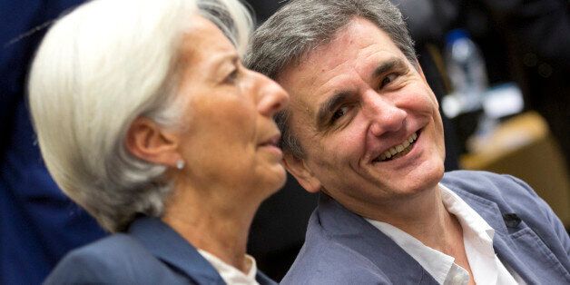 Greek Finance Minister Euclid Tsakalotos, right, speaks with Managing Director of the International Monetary Fund Christine Lagarde during a round table meeting of eurogroup finance ministers at the EU Lex building in Brussels on Sunday, July 12, 2015. Greece has another chance Sunday to convince skeptical European creditors that it can be trusted to enact wide-ranging economic reforms which would safeguard its future in the common euro currency. (AP Photo/Virginia Mayo)